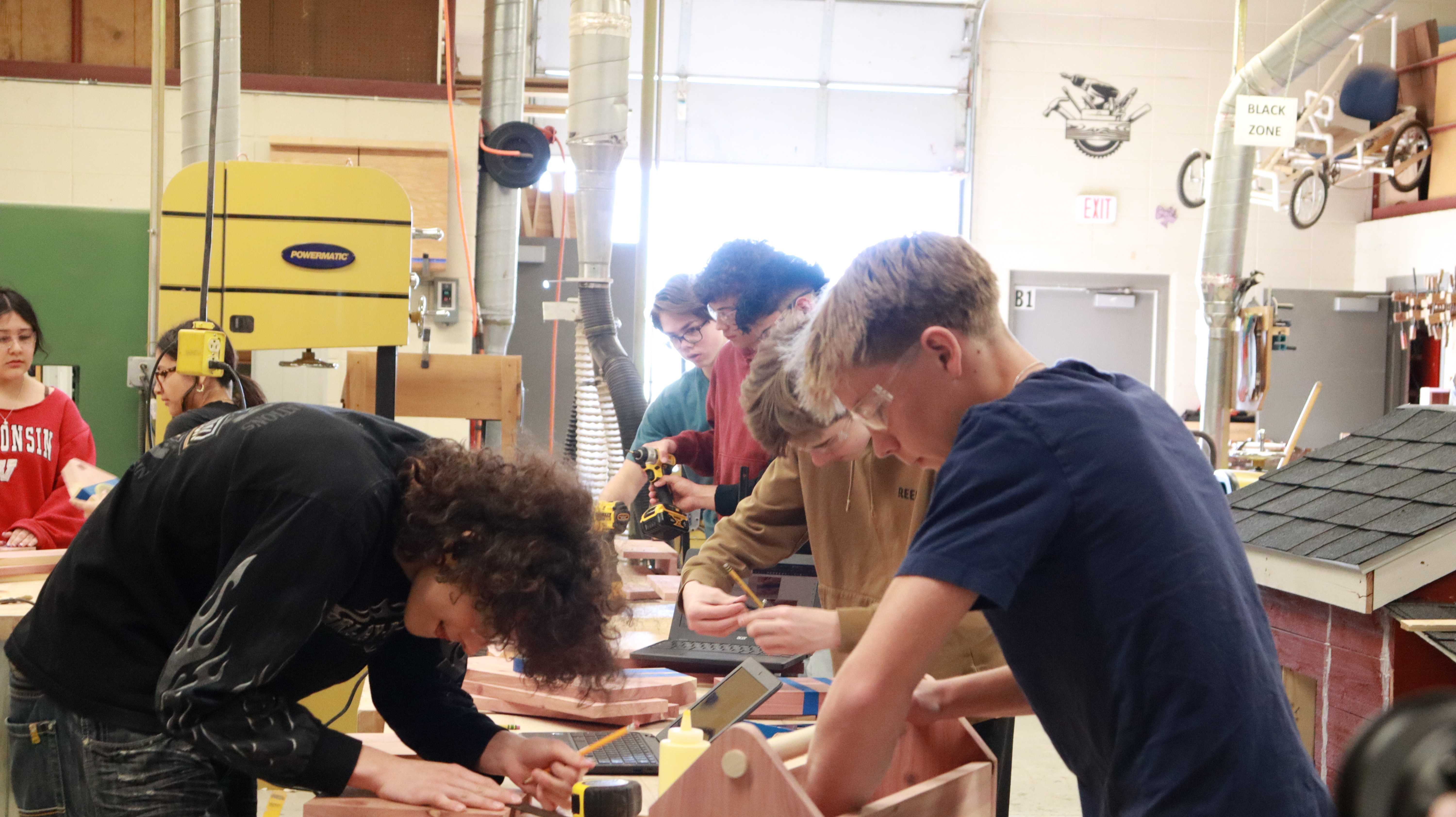 Students in woodworking class building their next project.